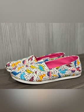 Toms White Slip-On Sneakers with Pink Lining and Multicolor Dinosaur Print